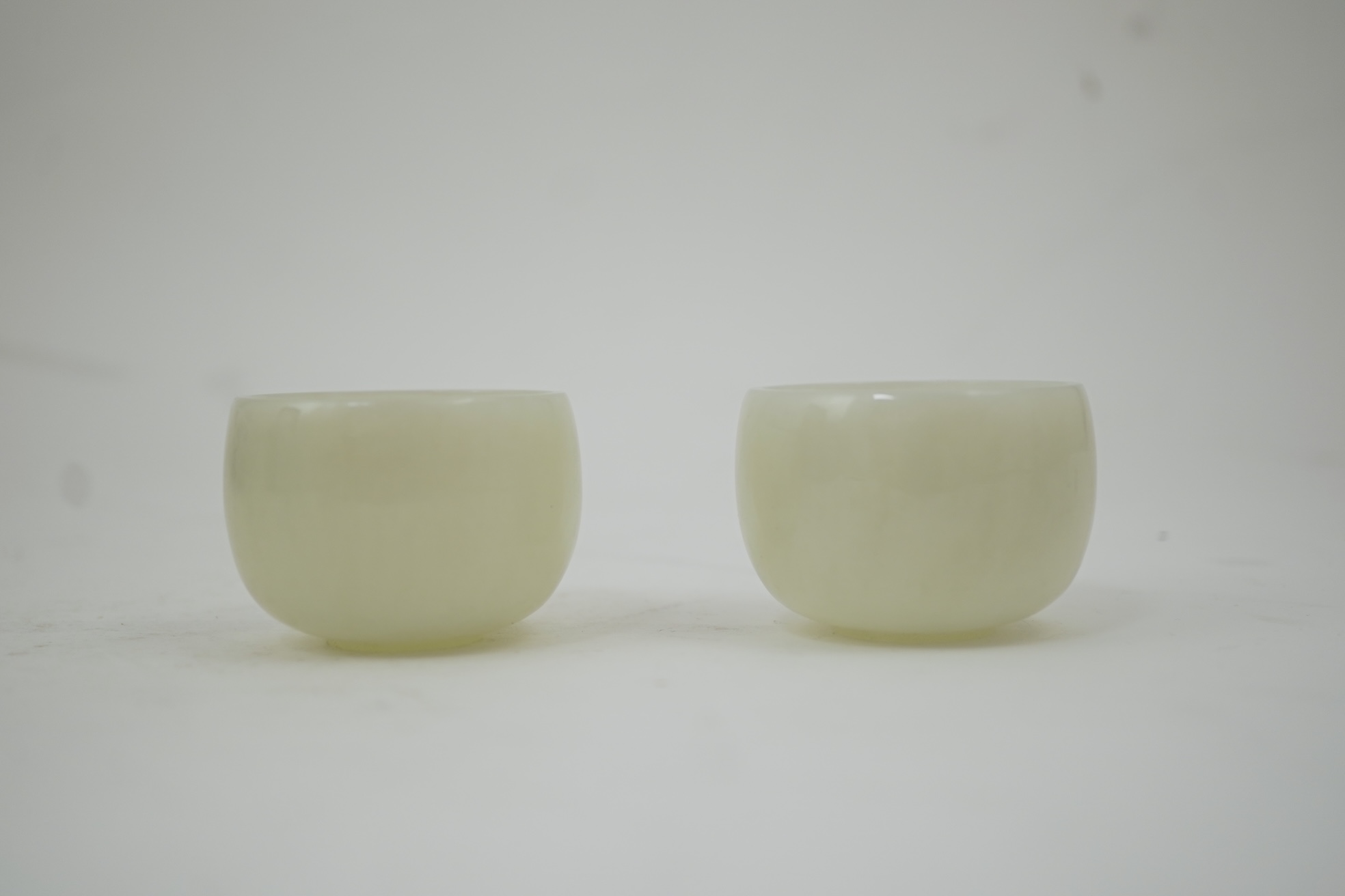 A pair of Chinese white jade cups, Qing dynasty or later